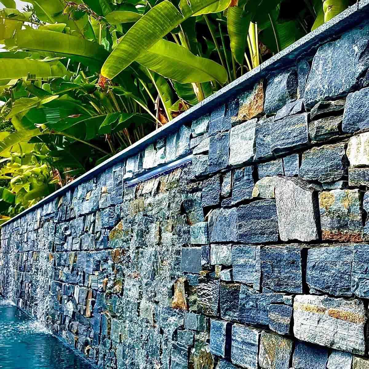 retaining wall with plants and waterfall